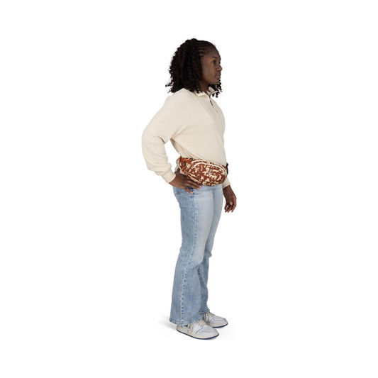 Osprey Daylite Mini waist pack in brown print, worn as belt bag and crossbody